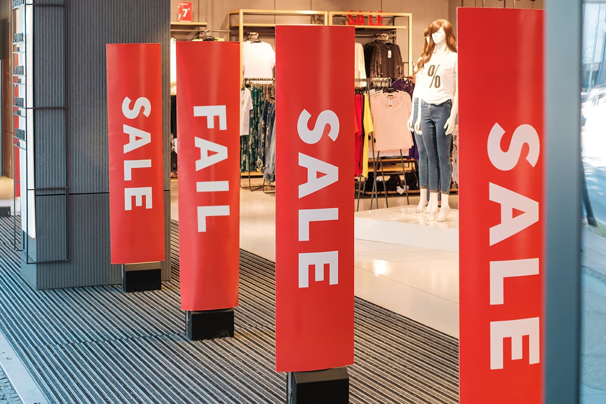 Store entrance with sale signs, one of the signs is wrong showing how important signage is for in-store campaigns