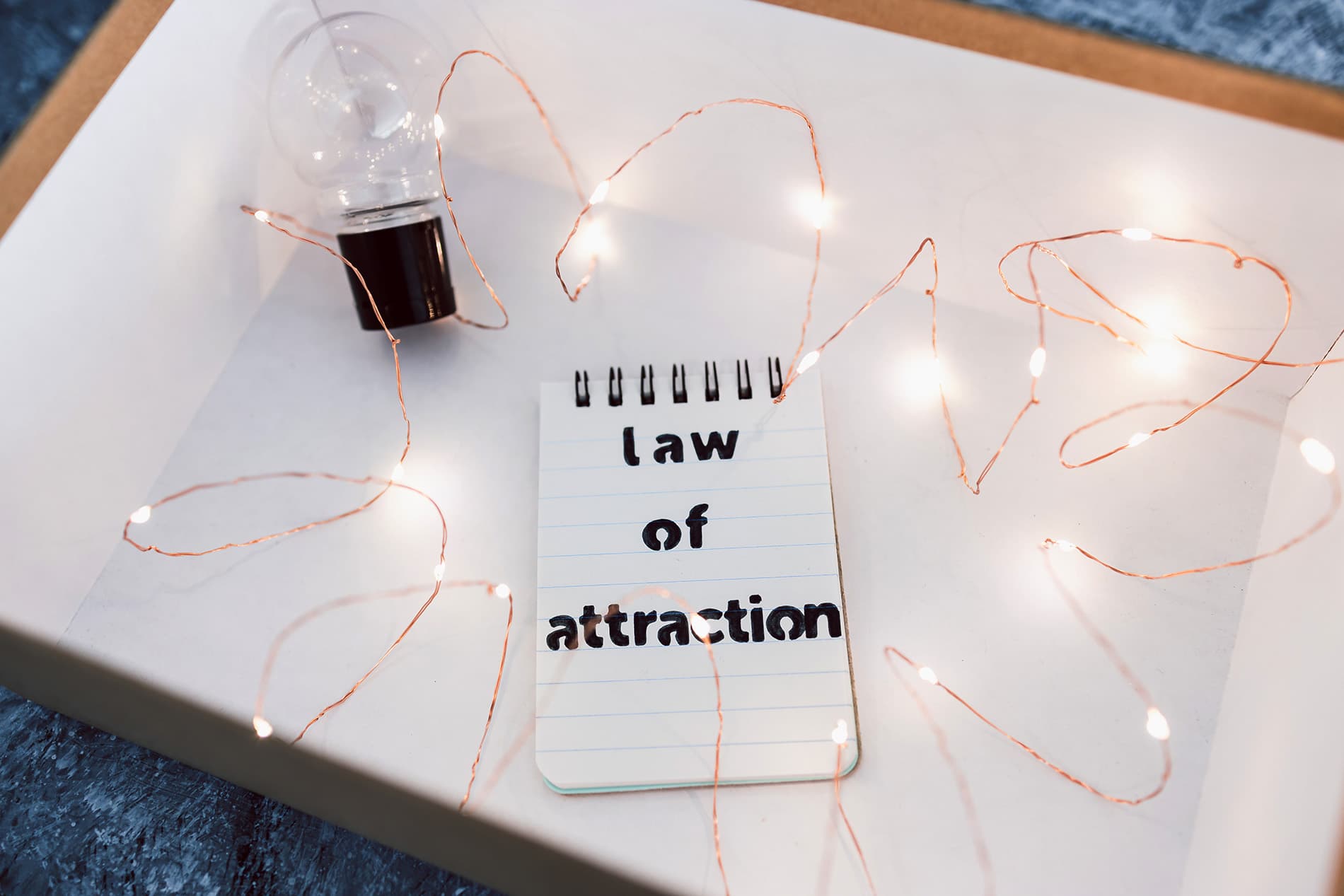 A notepad with Law of attraction written on it as a reminder that the right employees attract the right employees to the stores