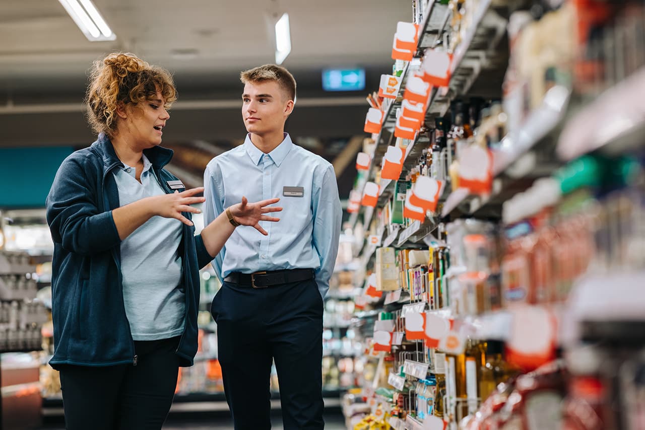 A new retail employee receiving an introduction in store from a colleague