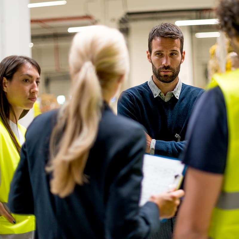 Staff meeting with three store employees and a manager.