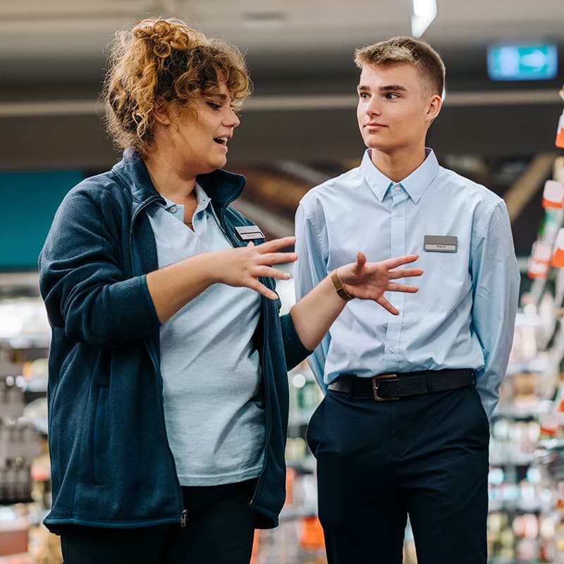 A store manager showing a new employee around the store.