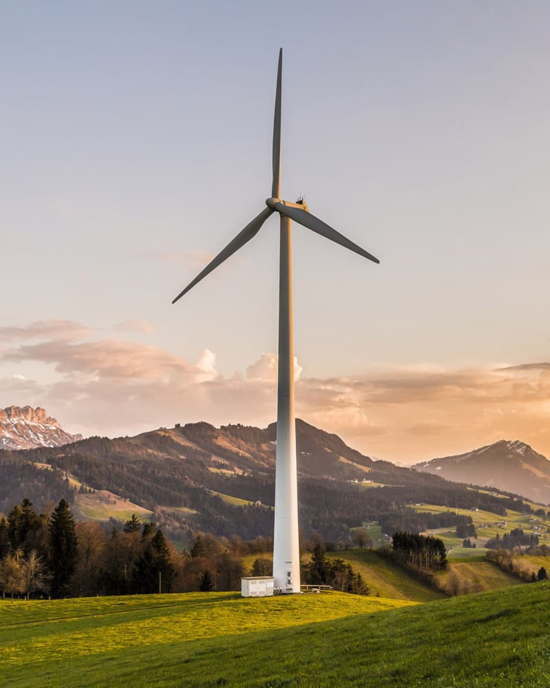 A wind turbine in a mountainous landscape.