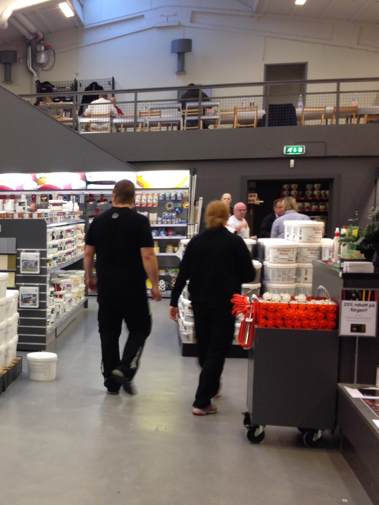 Store employees in a Caparol store helping customers